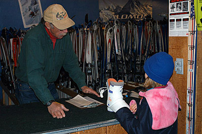 GIRL AT SKI RENTAL SHOP